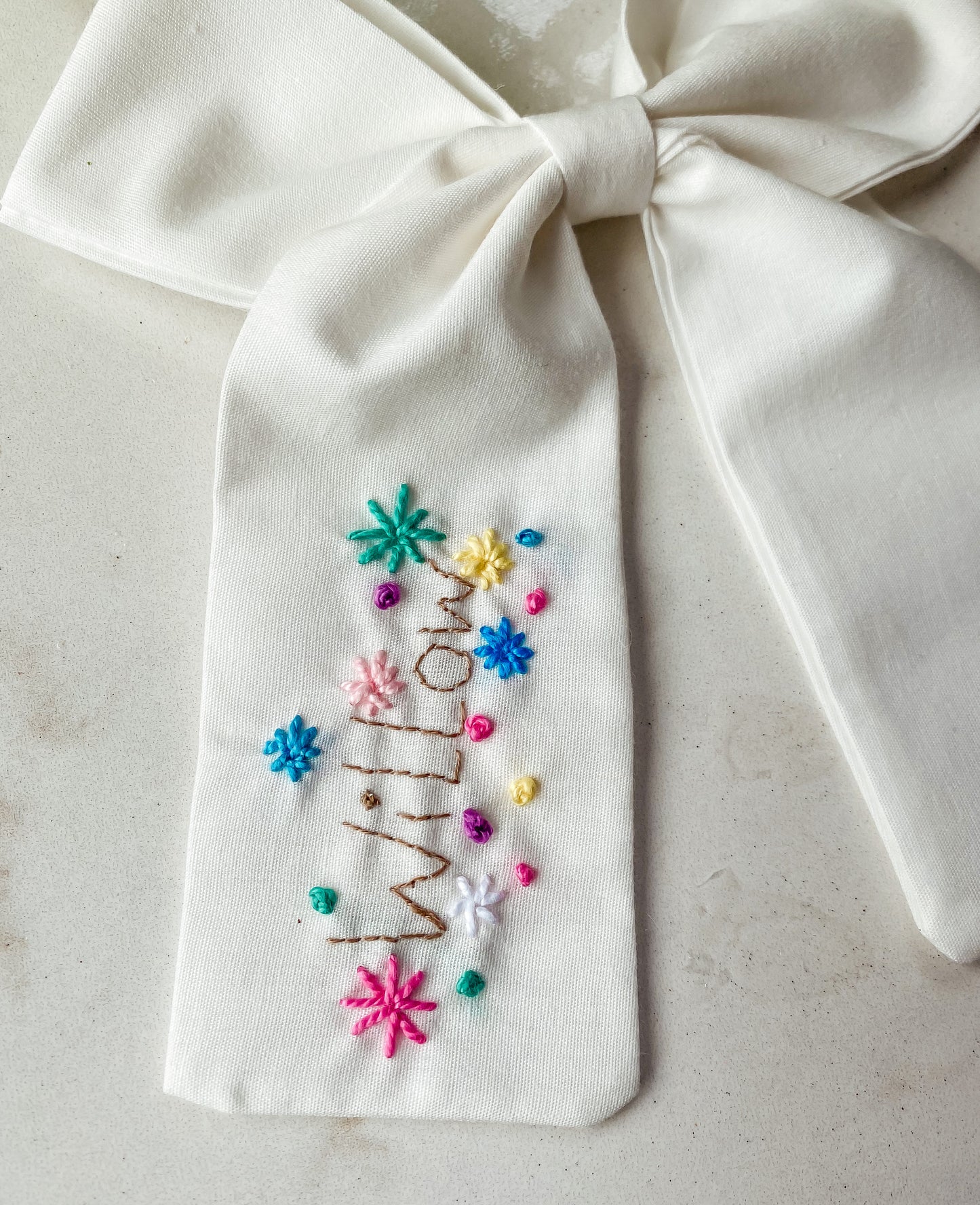 Embroidered name bow