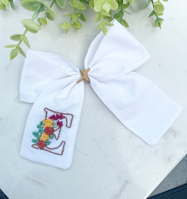 Hand embroidered initial bow with flowers
