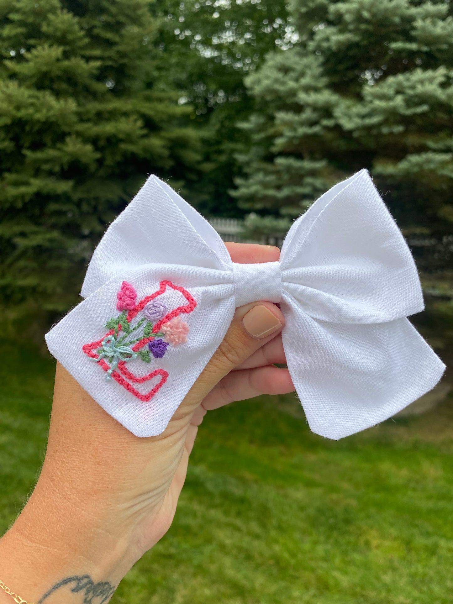 Hand embroidered initial bow with flowers