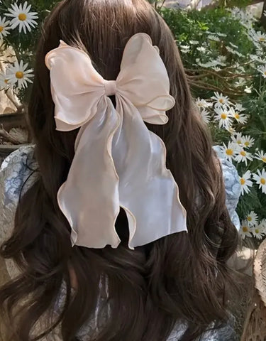 Elegant solid ribbon attached to a barrette