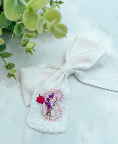 Hand embroidered initial bow with flowers