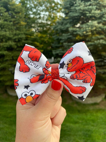 Red puppet, oversized bows